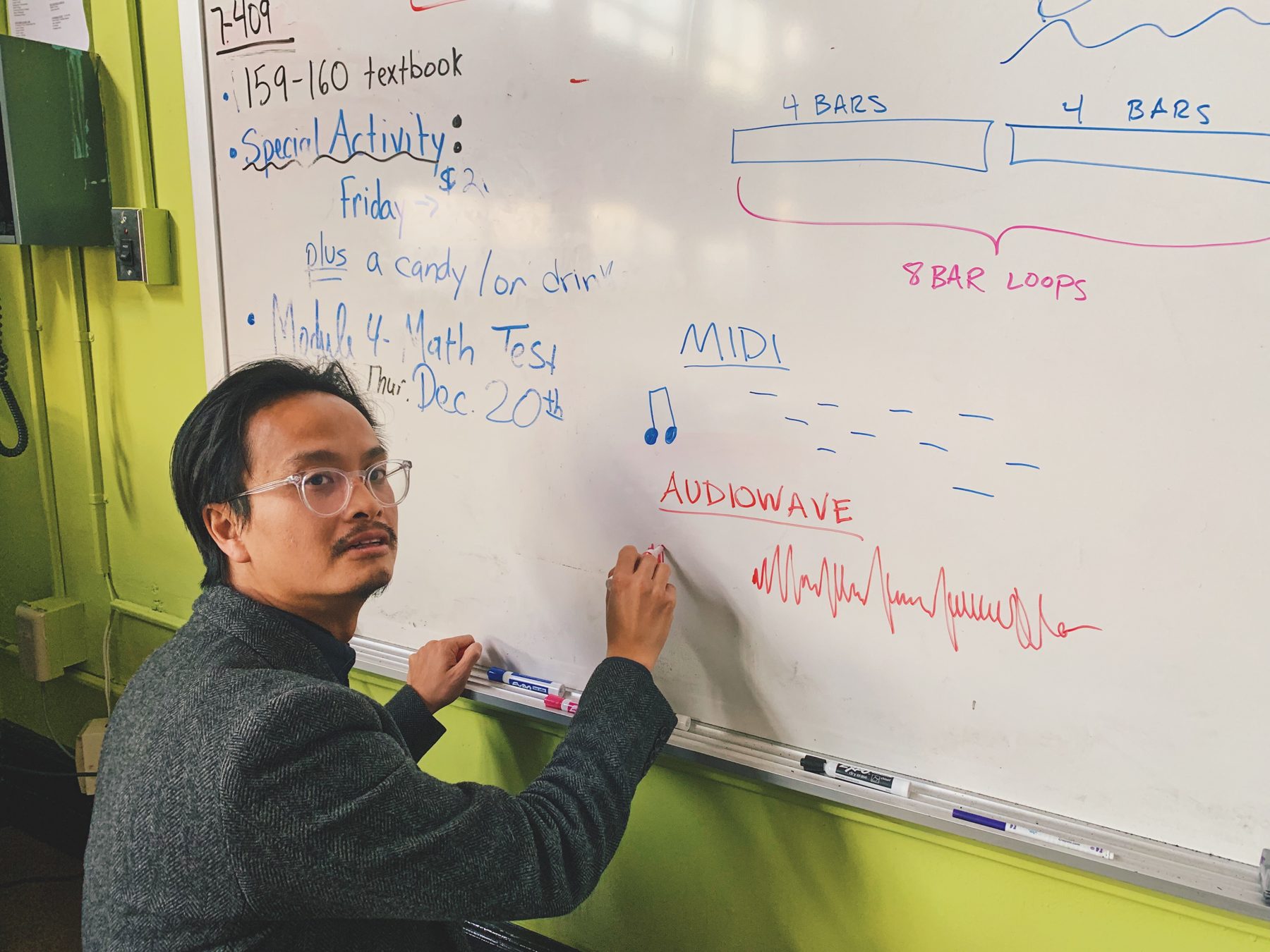 Phi writing MIDI and eight-bar loop notes on a classroom whiteboard